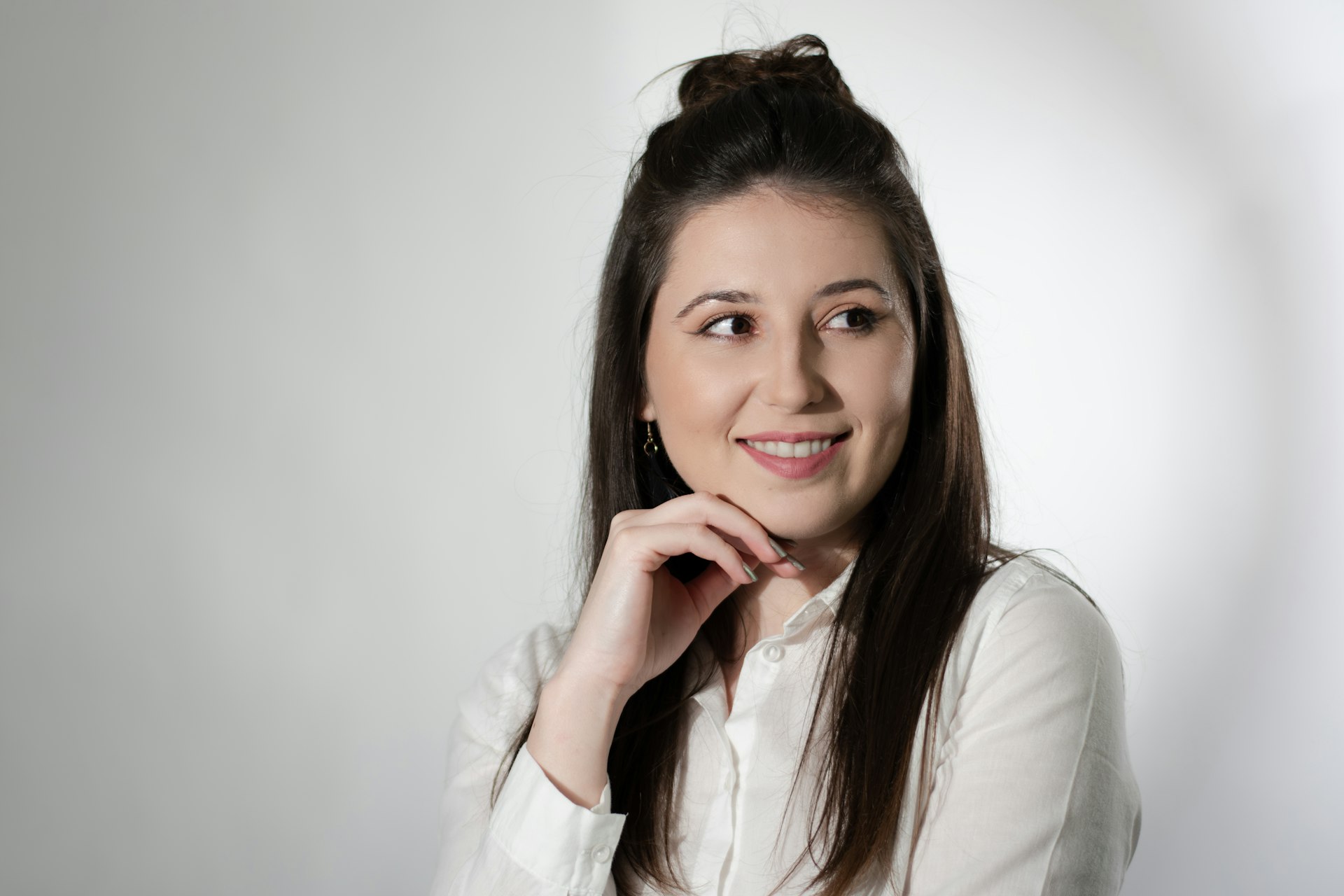 a woman posing for a picture in a white shirt